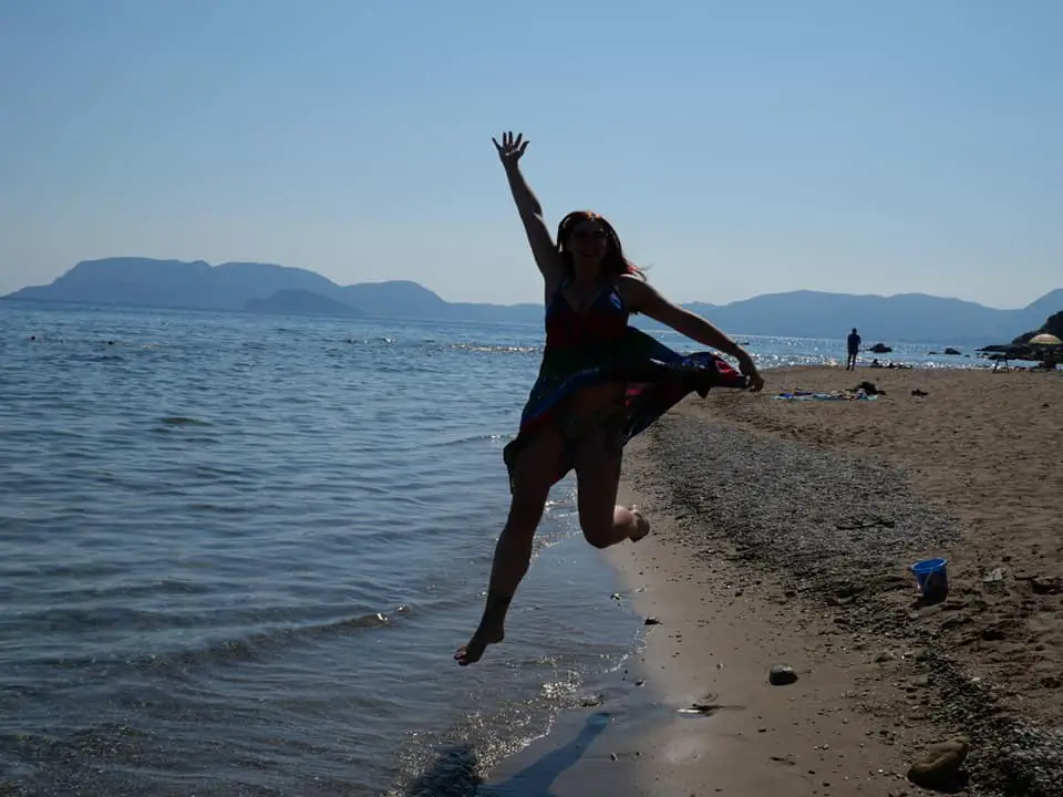 Travel to Zante | Silhouette of me jumping on the sand against the waves as the sun begins to set  