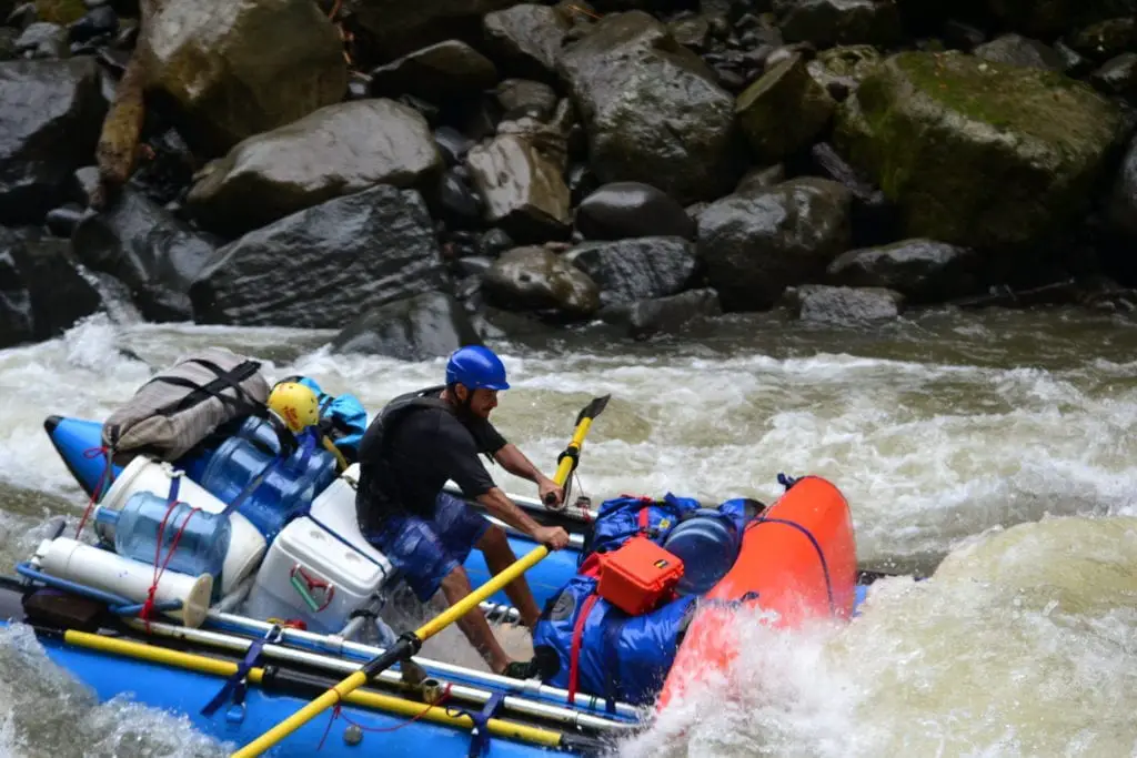 Top adventurous things to do in Costa Rica - a rafter transporting loads of kit down level IV rapids