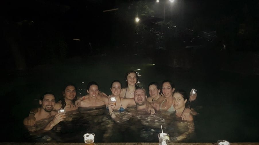 Things to do in Arenal Costa Rica -  A group of young people enjoying drinks in the natural hot springs at night