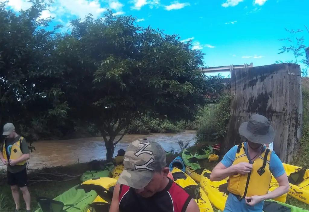 Top adventurous things to do in Costa Rica - group of people getting ready for kayaking through the jungle river
