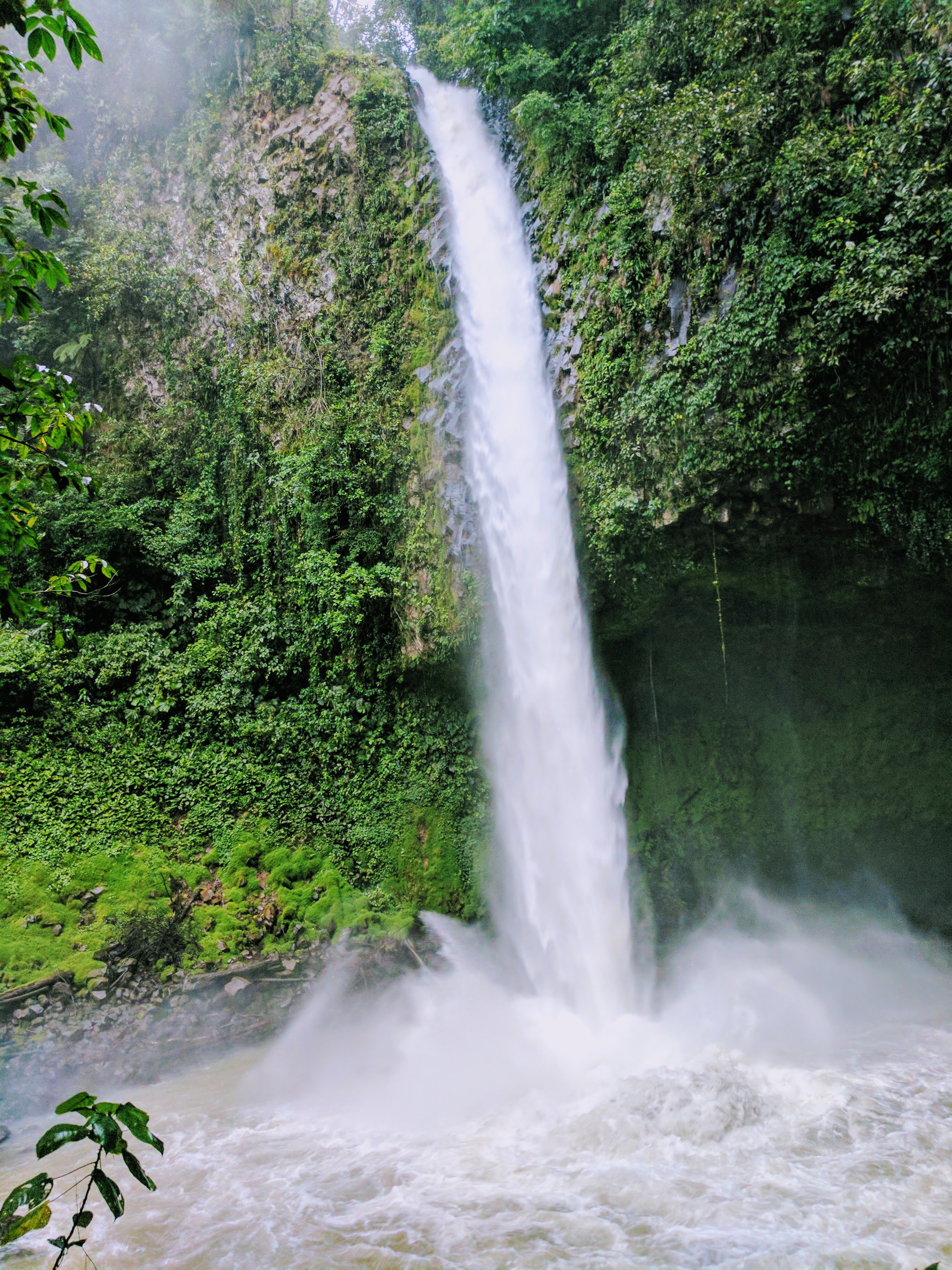 Things to do in Arenal, Costa Rica - view at the bottom of a tall waterfall