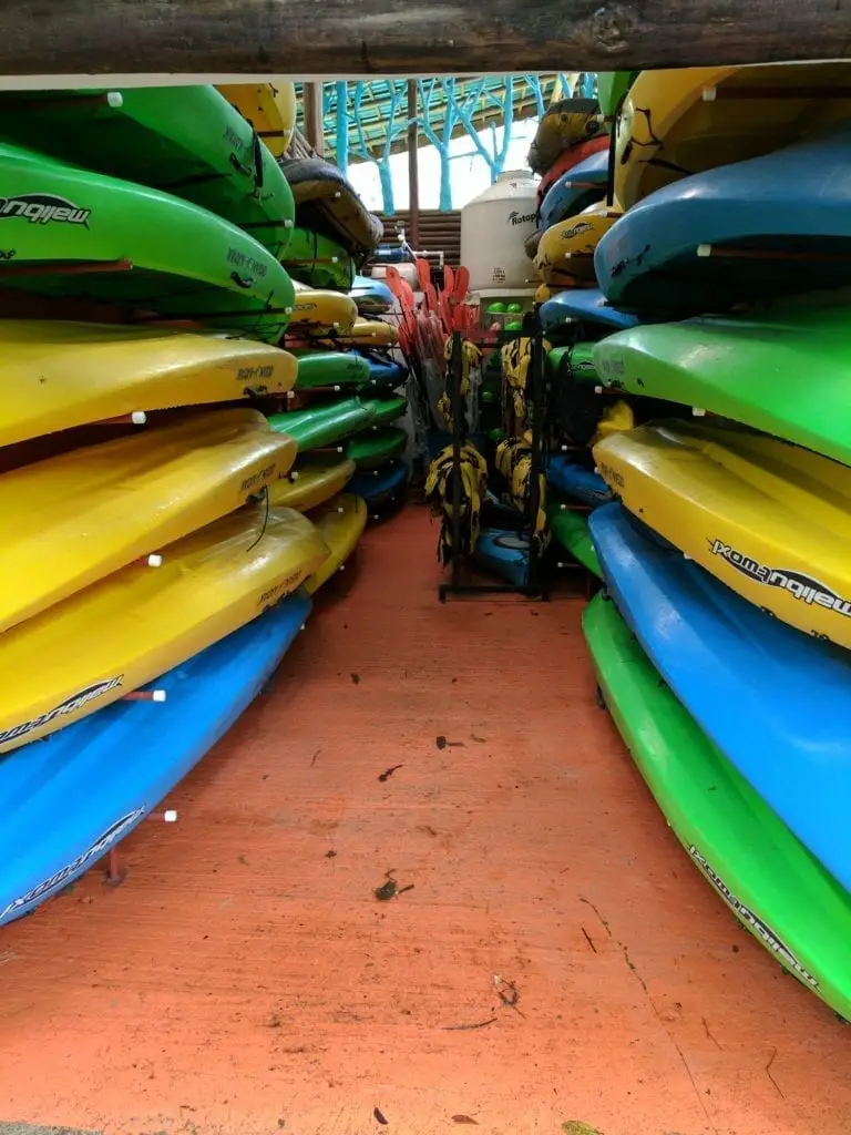 Costa Rica Itinerary - a room filled with colourful kayaks in Sarapiqui
