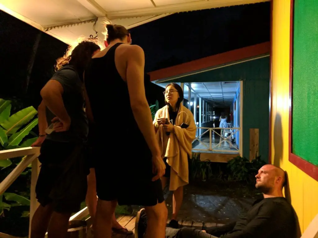 Pros and Cons of Group Tours - group discussing something while one person sits on the floor looking on