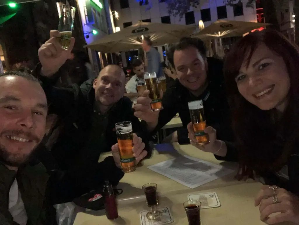 Things to do in Cologne Old Town - group of people sitting in an outside bar drinking Kolsch