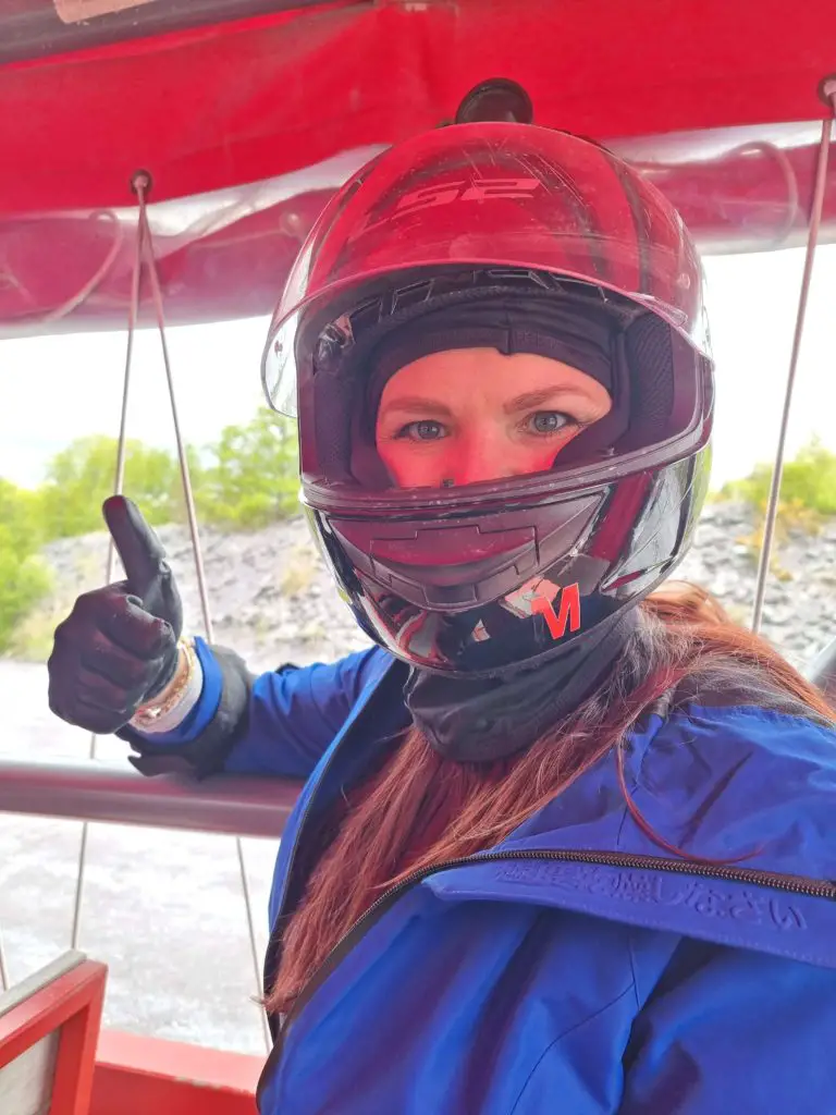 Zip World Karts - a woman with a crash helmet on giving the thumbs up on the ride up the quarry to go go-karting