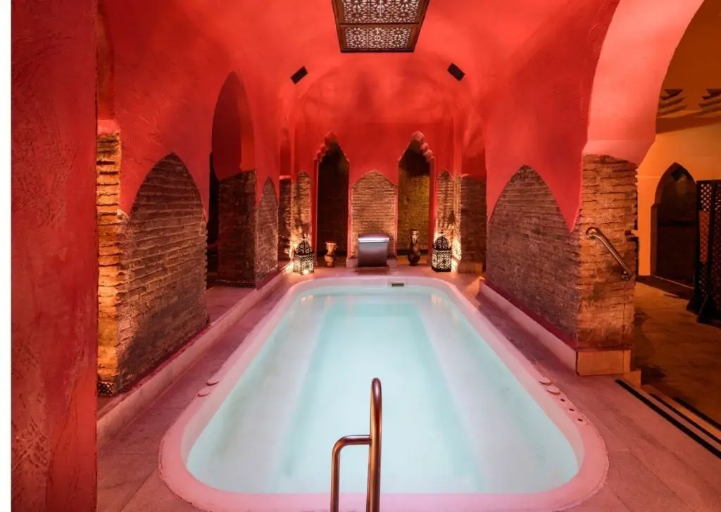 Epic things to do in Marrakech - lavish hamman public bath in red clay stone morrocan infused spa 