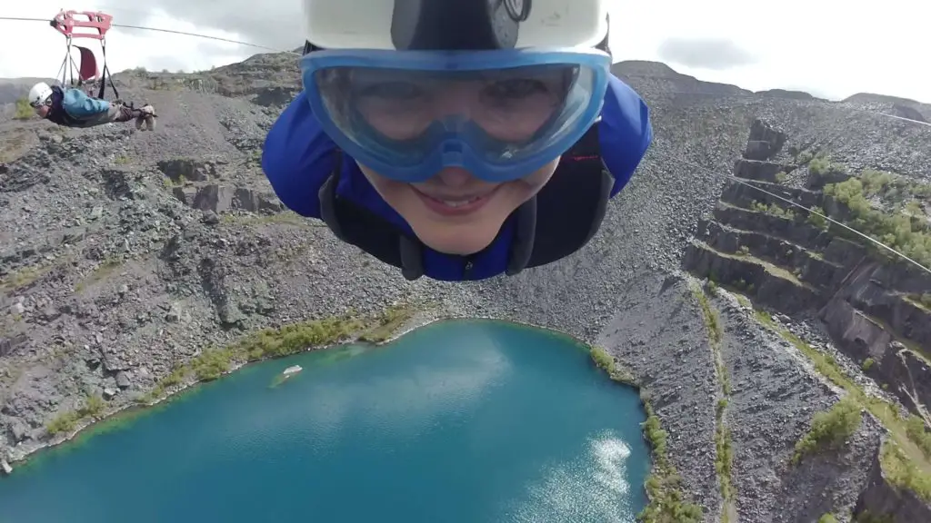 Top Adrenaline Activities UK - Penrhyn Zip Wire - woman gliding over the quarry in Zip world