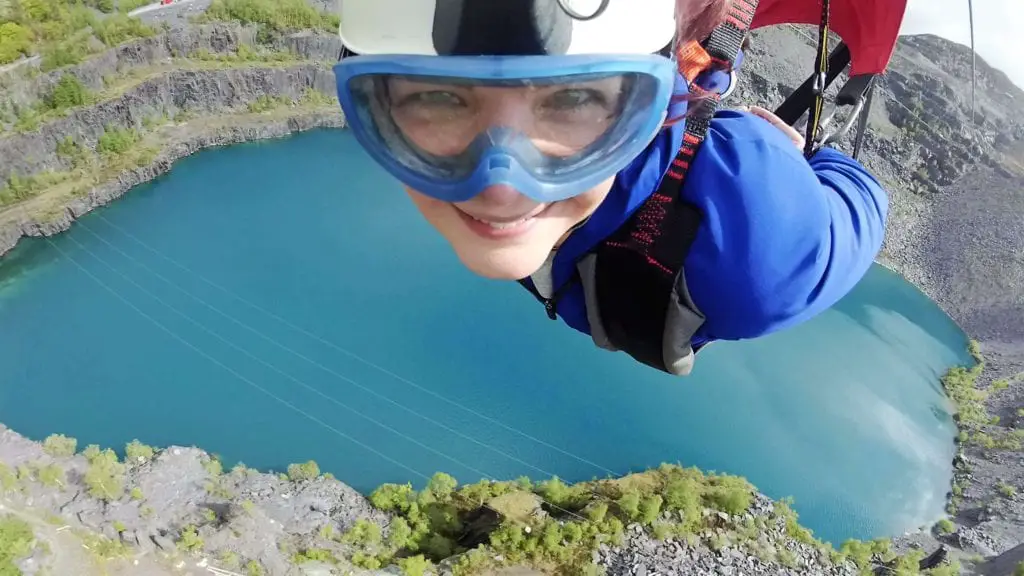 Penrhyn Zip Wire - Woman on velocity 2 zip wire across the quarry