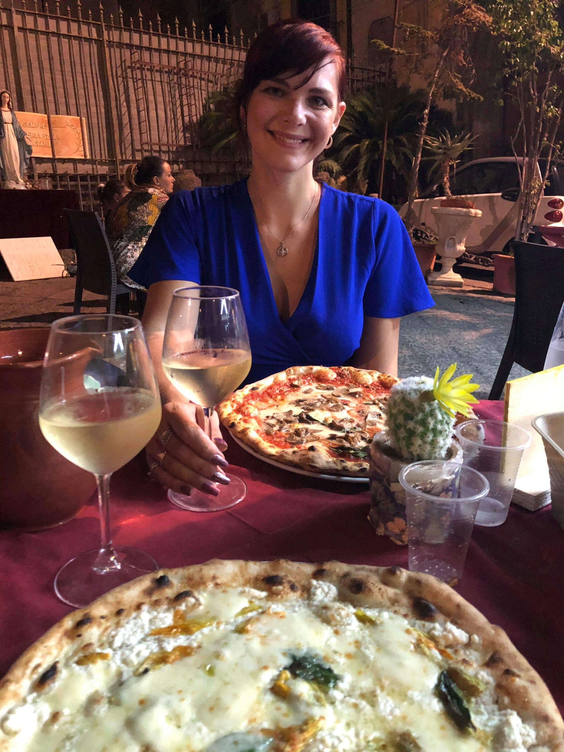 Things to do in Naples - woman eating a pizza in a pizzeria