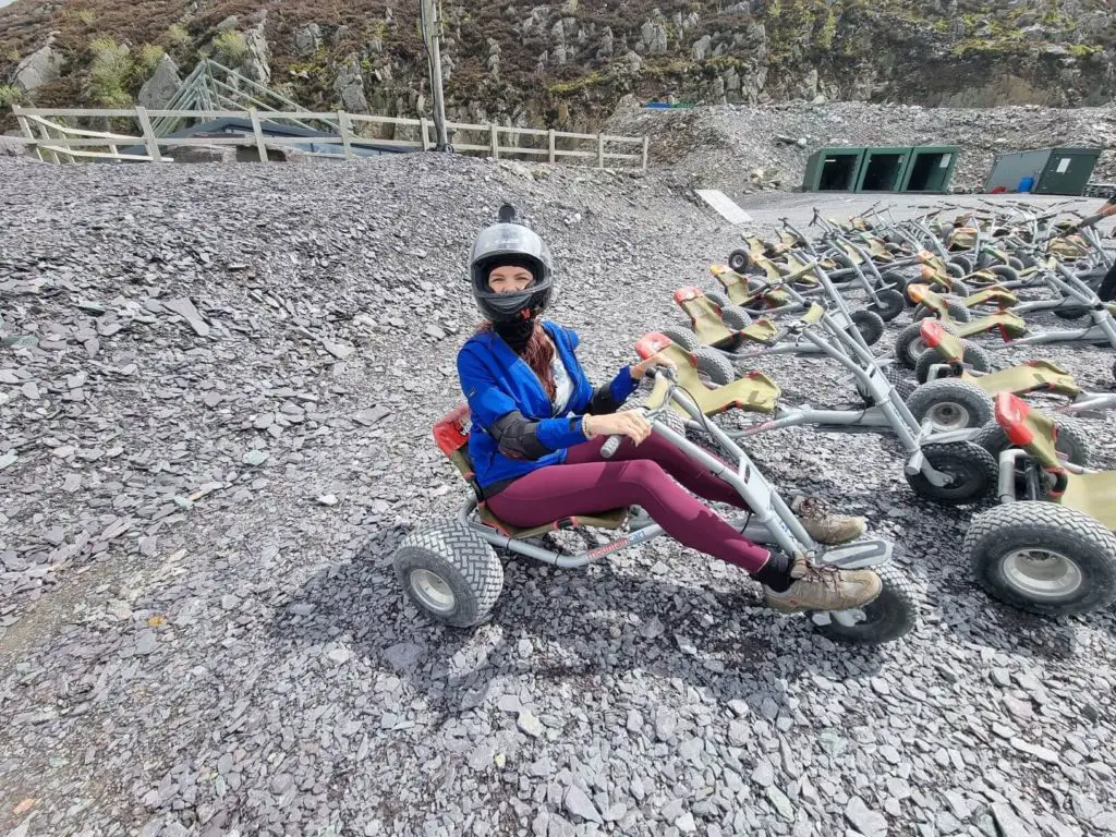 Top Adrenaline Activities UK, Zip World Karts | a woman on her go-kart getting ready for some adrenaline adventure sports