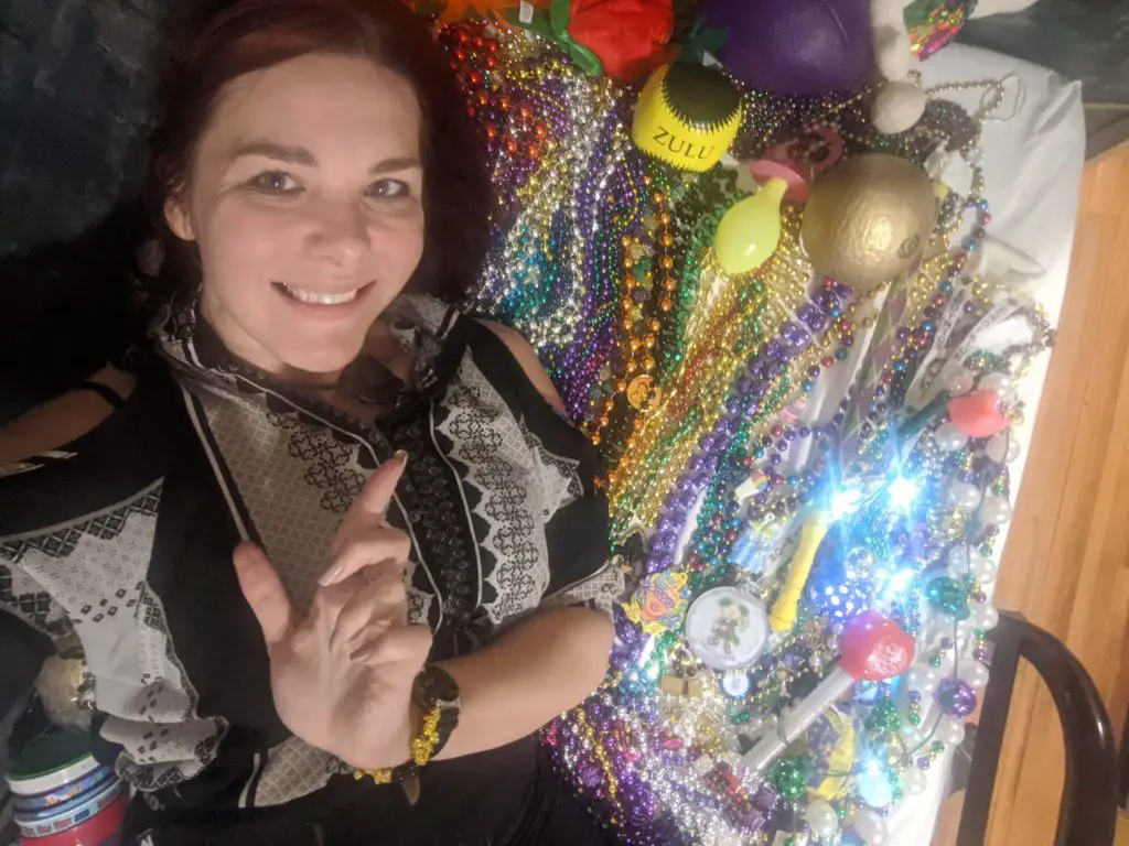 Mardi Gras Carnival New Orleans - woman with loads of beads and doubloons from the carnival