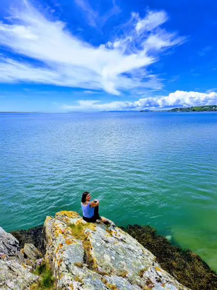 Things to do in portmeirion - sitting on a rock enjoying the sea view