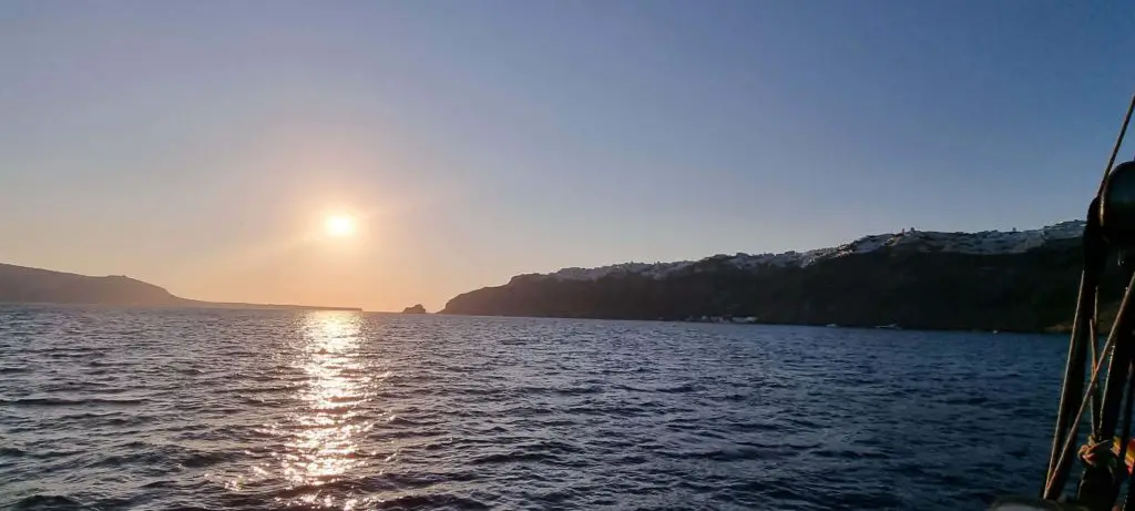 santorini itinerary 4 days - oia sunset from sea boat