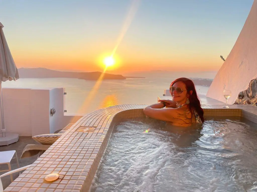 santorini itinerary 4 days - sunset view from the deluxe suite at regina mare hotel