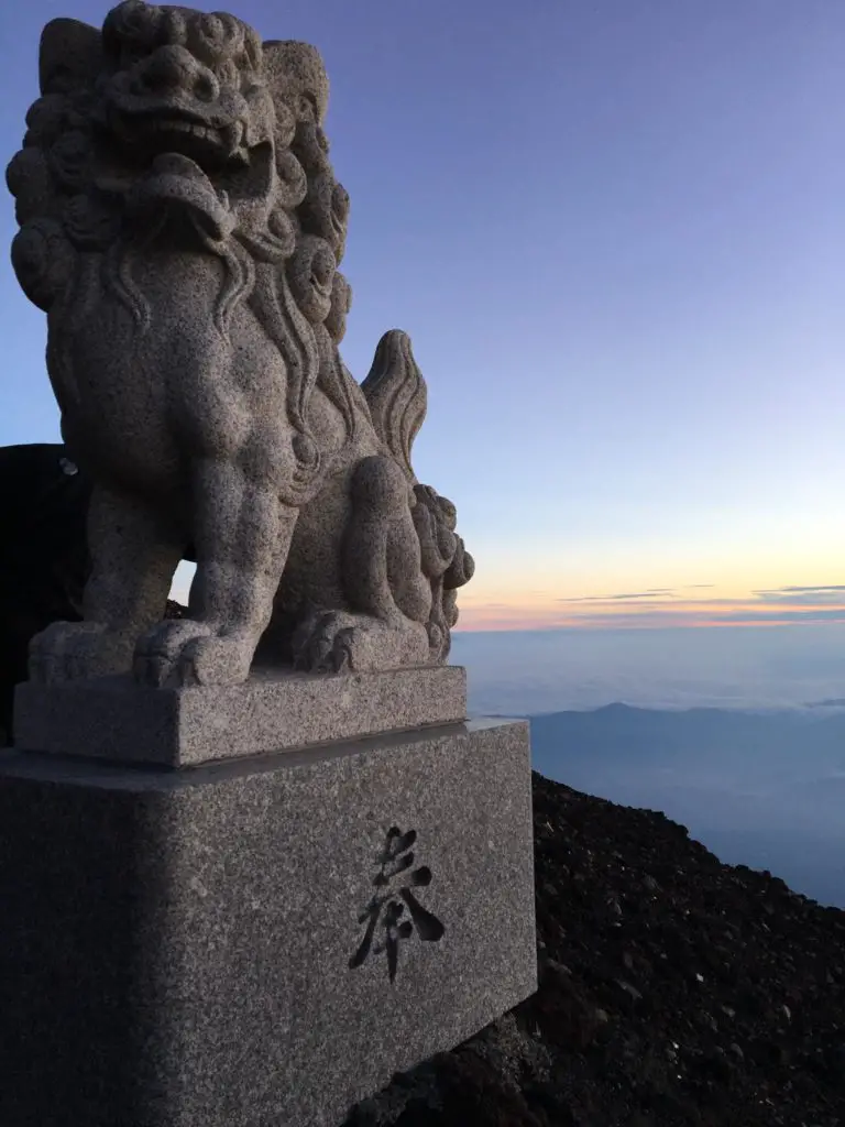 Japan Itinerary 10 days - a japanese stone statue at the summit of mount fuji