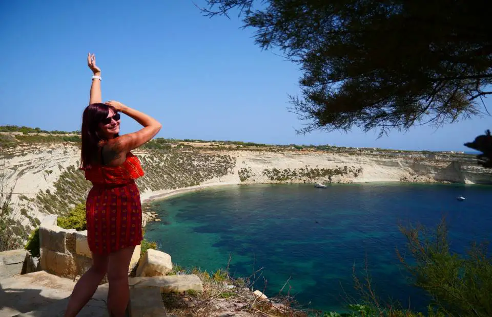 VeggTravel - Travel Inspiration, Ideas and Advice - Woman with arms up looking out to the ocean in Malta